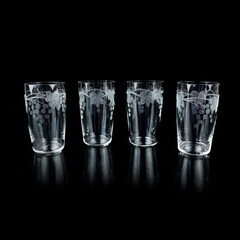 set of antique glasses with engraving. vintage wine glasses on a black isolated background