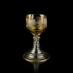 crystal vintage wine glass. antique yellow wine glass on a black isolated background