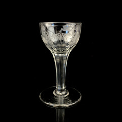 crystal antique wine glass. vintage glass goblet for alcoholic beverages on a black isolated background