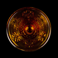 crystal antique orange urn. vintage colored glass urn with engraving on a black isolated background