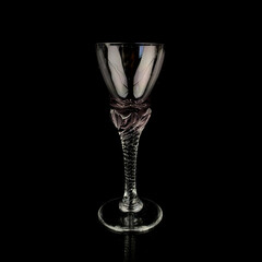 pink antique crystal frame. vintage glass with a curly stem on a black isolated background