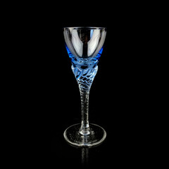 blue antique crystal frame. vintage glass with a curly stem on a black isolated background