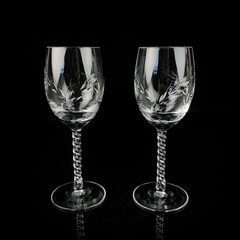 set of crystal antique wine glasses. vintage glass set of glasses for alcoholic drinks on a black isolated background