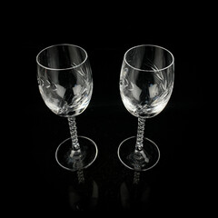 set of crystal antique wine glasses. vintage glass set of glasses for alcoholic drinks on a black isolated background