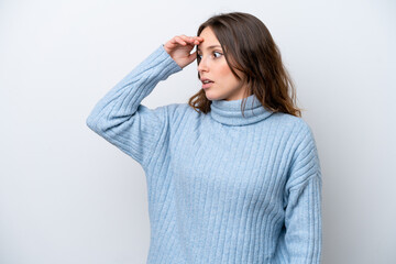 Young caucasian woman isolated on white background with surprise expression while looking side