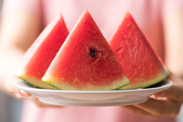 Sliced watermelon holding by hand, Tropical fruit in summer season