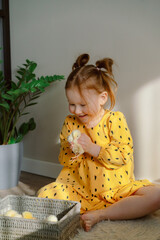 Girl in a yellow dress with a basket of chickens