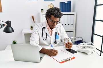 Young south east man wearing doctor uniform holding pills at clinic