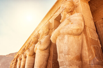 Statues of pharaohs as columns in the temple of Queen Hatshepsut in the Nile Valley in Luxor. Travel and tourism in Egypt