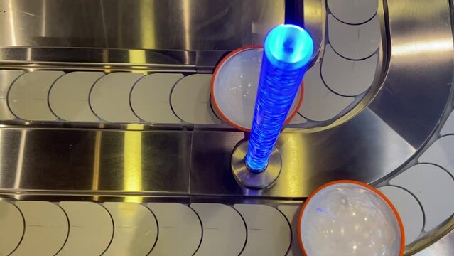 Close-up top view conveyor belt with empty plates on it. Containers revolve around sushi bar. Kaiten sushi restaurant