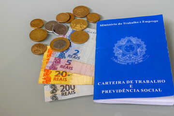 Brazilian money, work card and coins. Income tax. declaration