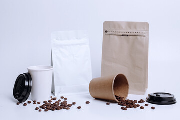 Pouch bags with zip lock and valve, paper cups and seeds on white background, coffee set mock up....