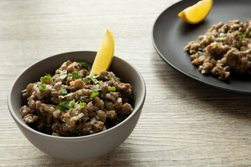 Lentil salad with homemade mustard and lemon juice wedge. Ethiopian cuisine. Azifa dish with senafich spice.