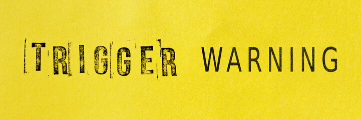 Trigger warning sign message on yellow background. Stamp letters mental triggering concept.