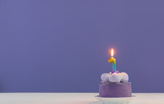 Purple Birthday Cake With Burning Candles On Purple  Background