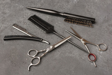 Stylish professional barber scissors, hair cutting shears on black background. Hairdresser salon equipment concept, hairdressing set