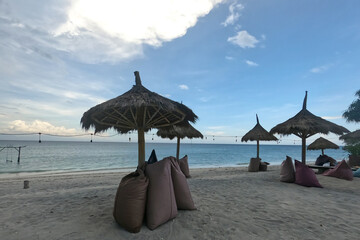 Many bean bags outdoor on the sand beach for relaxing with ocean view