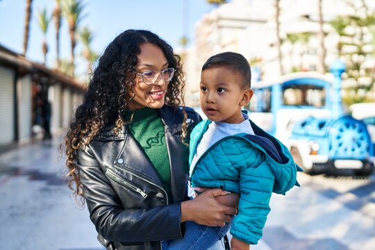 Mother and son hugging each other standing at street