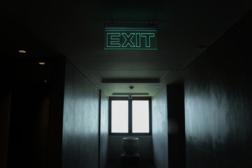 Exit sign on the dark hallway 