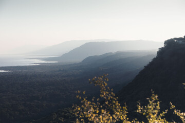 Scenir view of Manyara lake at sunset, touristic sight in tanzania, with cliffs and the national...
