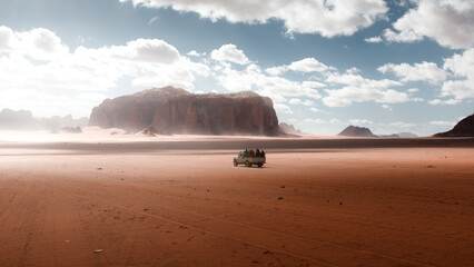Tourist jeep tour in Wadi Rum desert in Jordan, natural landscape surrounded by dry and rocky...