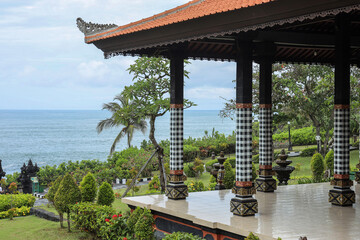 Balinese gazebo with sea view surrounded by green garden 