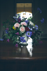Colorful bouquet with rose anemone, roses on a wood table