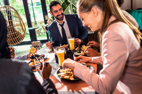 Group of business people in restaurant at lunch.