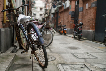 Fototapeta na wymiar Bicycles and scooters in typical Shanghai residential area.