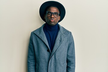 Young african american man wearing elegant style puffing cheeks with funny face. mouth inflated...