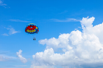 Parasailing above the ocean at tropical islands. Holiday fun activities. Copy space for tourism and love relationship 