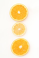 Flat lay of the three orange slices lying isolated on white background