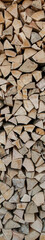 Natural wooden background. Chopped firewood. Firewood is stacked and prepared for winter.