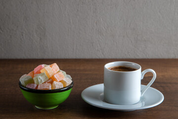 Traditional Turkish delight and Turkish coffee on a wooden background