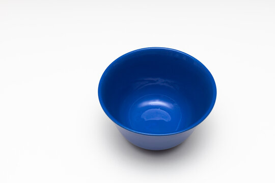 a blue porcelain bowl stands on a white background
