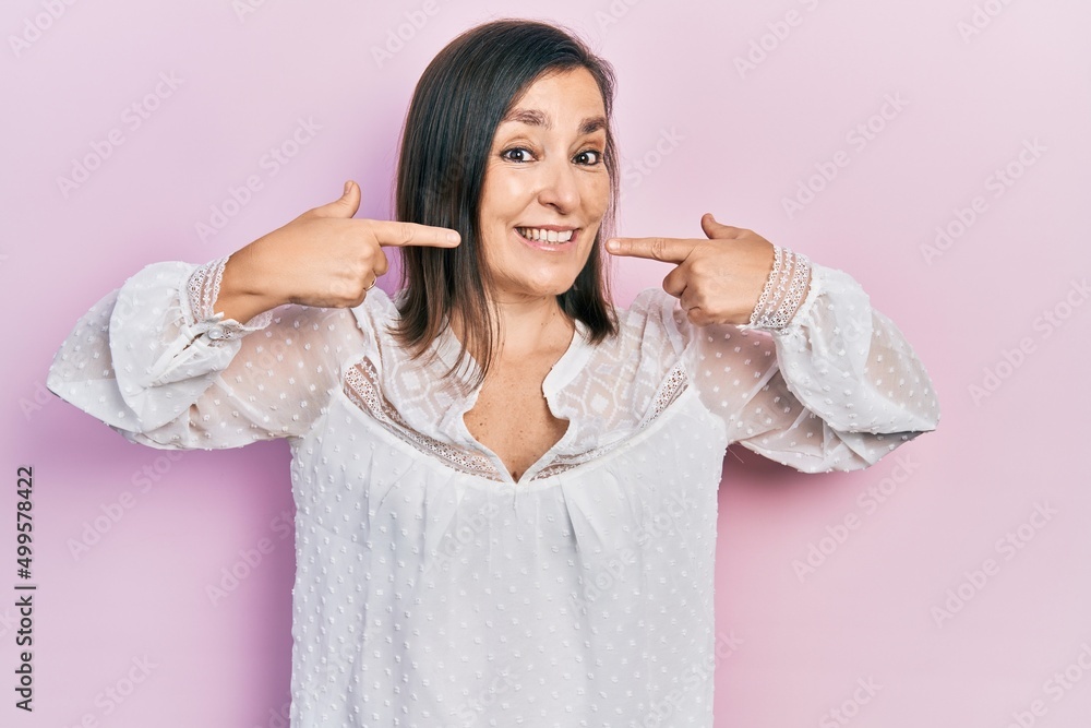 Sticker middle age hispanic woman wearing casual clothes smiling cheerful showing and pointing with fingers 