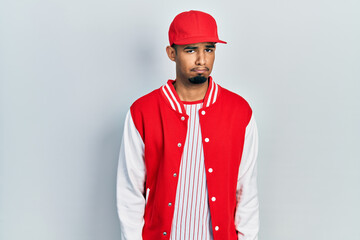 Young african american man wearing baseball uniform skeptic and nervous, frowning upset because of problem. negative person.