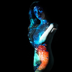 Projection from beamer or projector on woman looks like body painting - obrazy, fototapety, plakaty