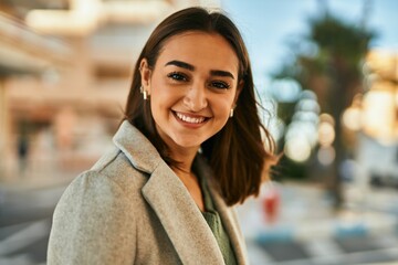 Young hispanic girl smiling happy standing at the city.