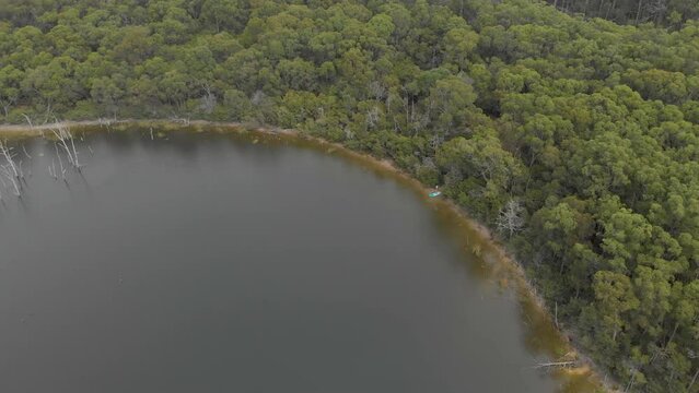 Aerial birds eye view of bushland around a lake in baw baw Australia.