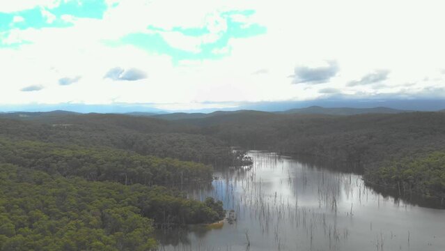 Aerial orbit around blue rock lake in baw baw country.