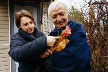 females,white people,males,farm,agriculture,agricultural activity,livestock,yard - grounds,chicken - bird,pets,poultry,egg,nature,organic,compost,chicken coop,brown,care,farmer,love - emotion,living o