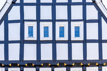 old half-timbered house facade with windows 