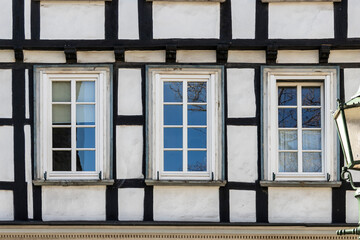 Fototapeta na wymiar old half-timbered house facade with windows 