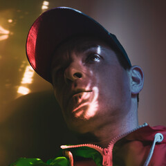 adult man with cap taking a selfie in the shadows