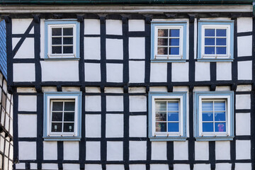 old half-timbered house facade with windows 