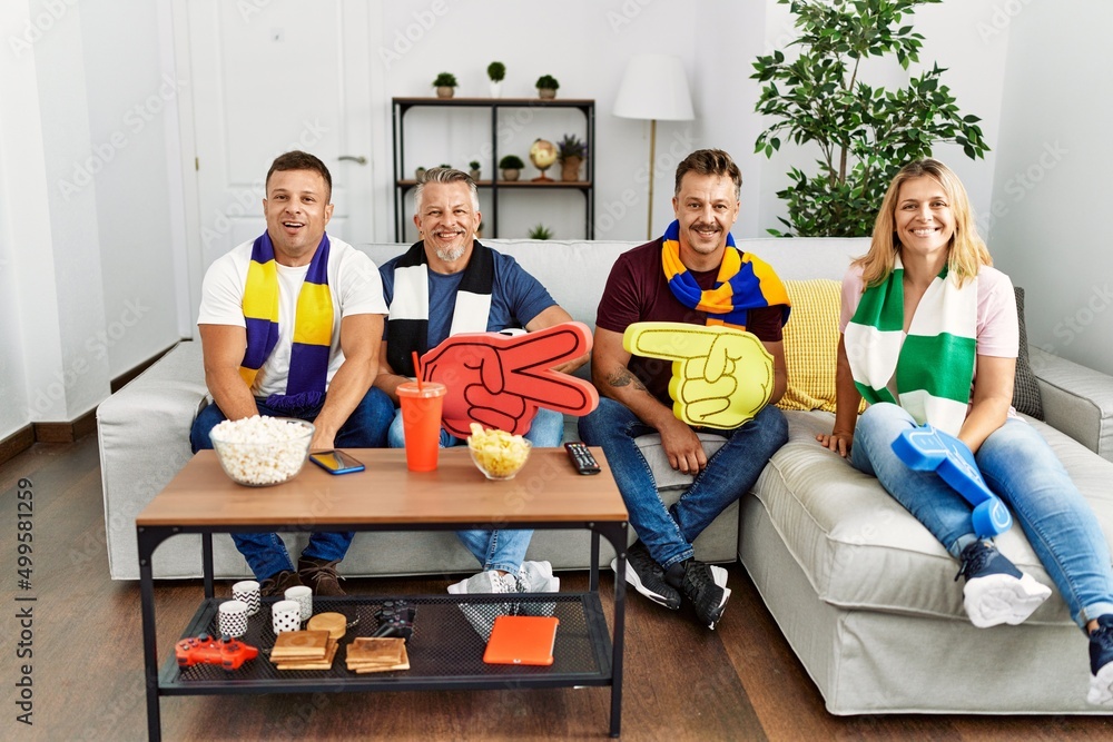 Canvas Prints Group of middle age people wearing team scarf cheering football game looking positive and happy standing and smiling with a confident smile showing teeth