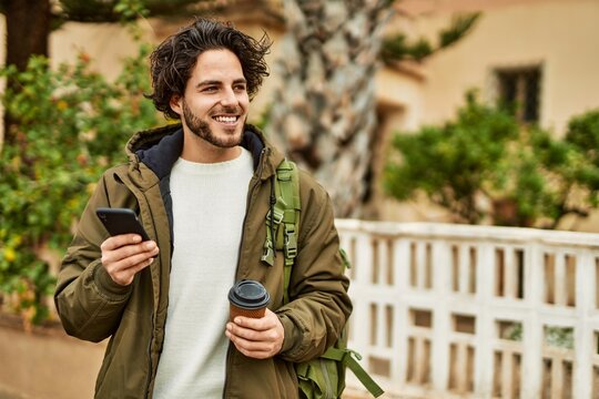 Handsome hispanic man using smartphone at the city