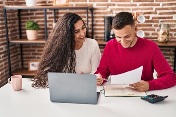 Man and woman couple calculating family economy at home