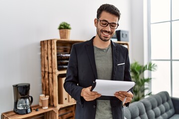 Young hispanic man having psychology session holding checklist at clinic